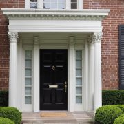 brick house facade with black entry door