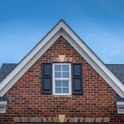 A closeup of a double-hung window on a red brick house